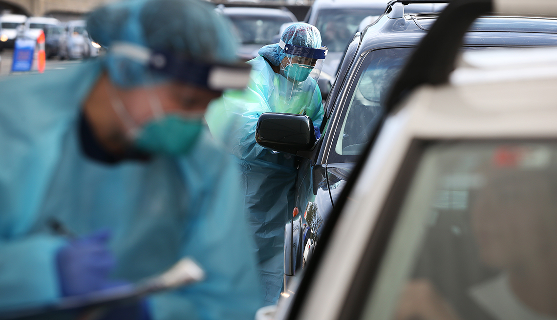 Registered nurses Michelle Gibbons and Debbie Bhatti conduct COVID-19 swab tests as large crowds queue at a Bondi Beach drive-through testing clinic on July 22, 2020 in Sydney, Australia. 