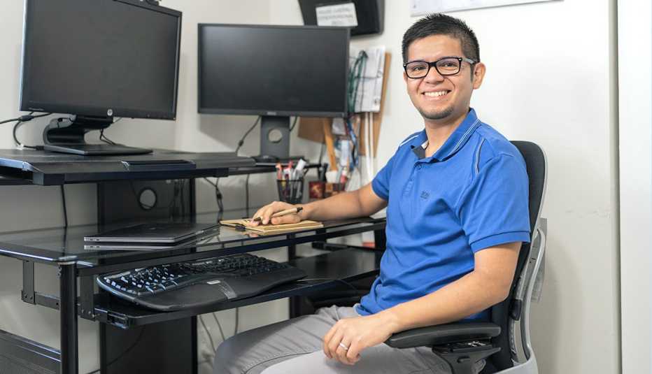AARP Fraud Volunteer Giancarlo Berrocal poses for a portrait in his home in Boca Raton, Florida on April 6, 2023.