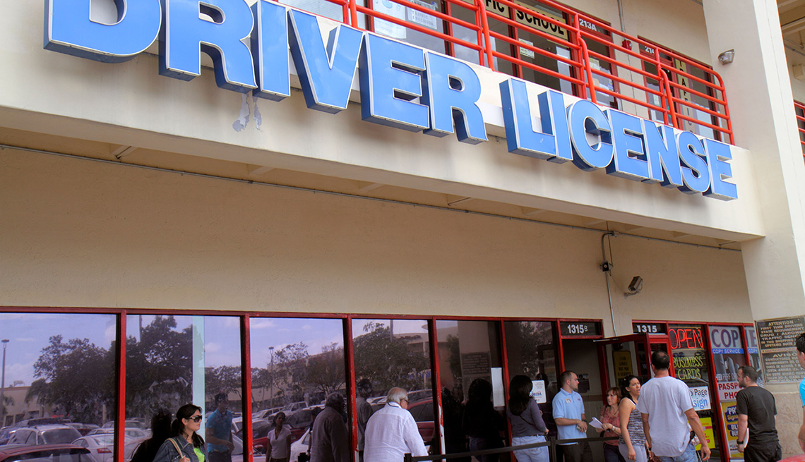 People standing outside, in a line awaiting to enter the Department of Motor Vehicles