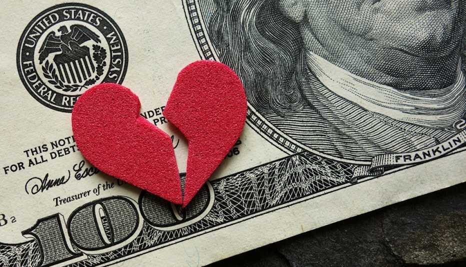 Broken red heart on a hundred dollar bill
