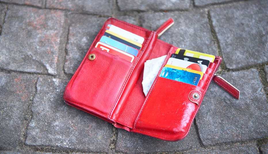 an open wallet on the ground with credit cards and receipts in it