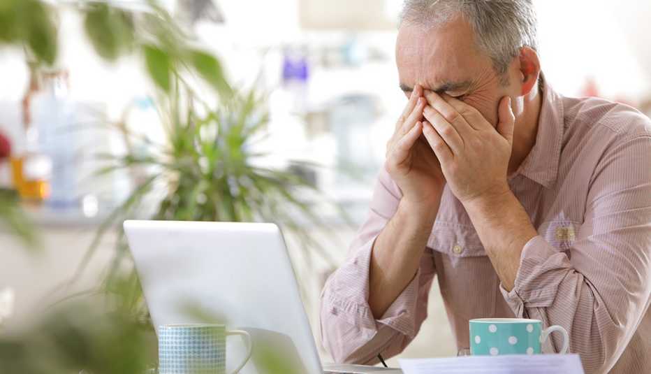 Man stressed, staring at computer