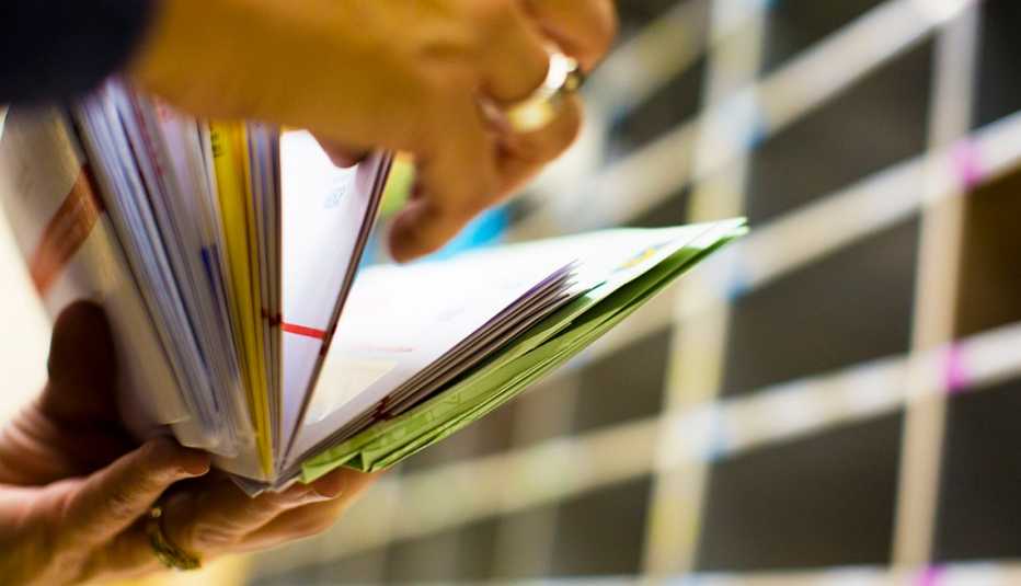 Hands flipping through mail