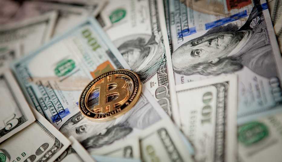 Golden Bitcoin on US dollar bills. Electronic money exchange concept. Golden Bitcoin on US dollar bills. Electronic money exchange concept.