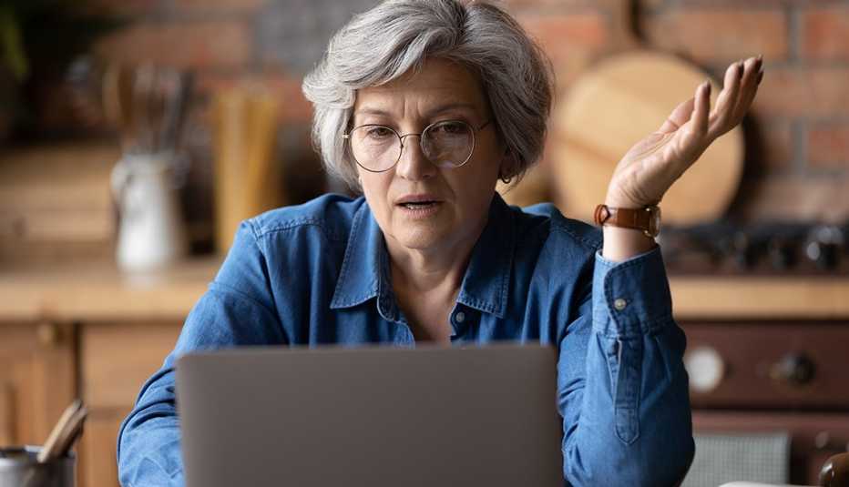 Woman in glasses looking at computer screen, stressed of getting message with bad news. Unhappy mature lady feeling nervous about bad laptop work or poor internet connection. Woman in glasses looking at computer screen, stressed of getting message with bad news. Unhappy mature lady feeling nervous about bad laptop work or poor internet connection.