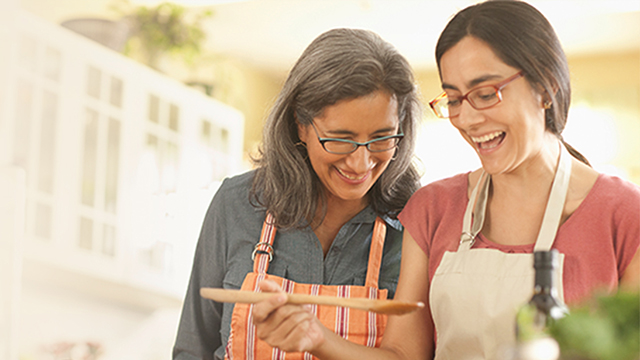Two women cooking together in a home kitchen