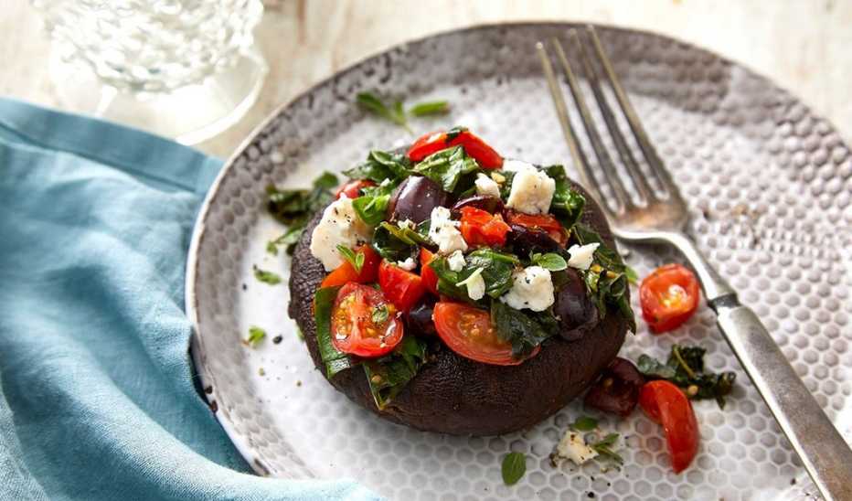 A close-up view of Greek stuffed portobello mushrooms on a plate