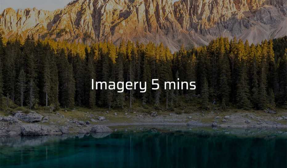 A body of water with trees and mountains in the background with the text "Imagery 5 mins"
