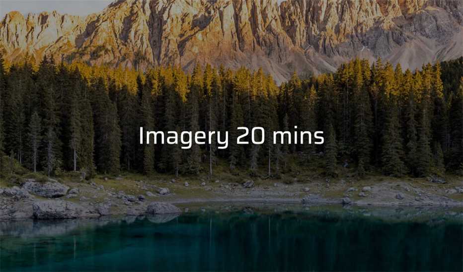 A body of water with trees and mountains in the background with the text "Imagery 20 mins"