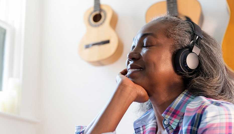 A woman listening to something with headphones on