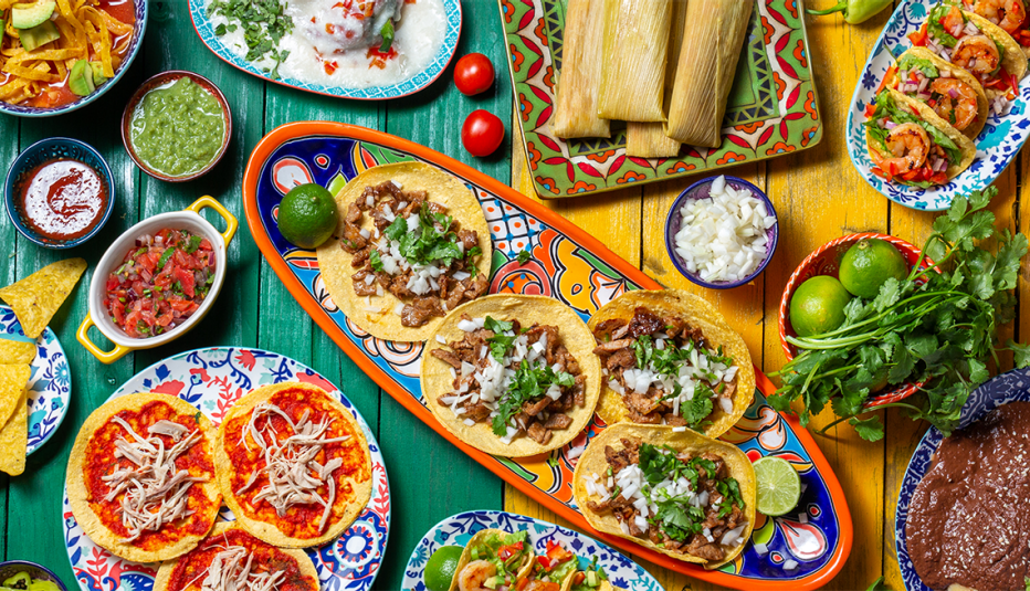 An overhead view of plates of different Mexican foods