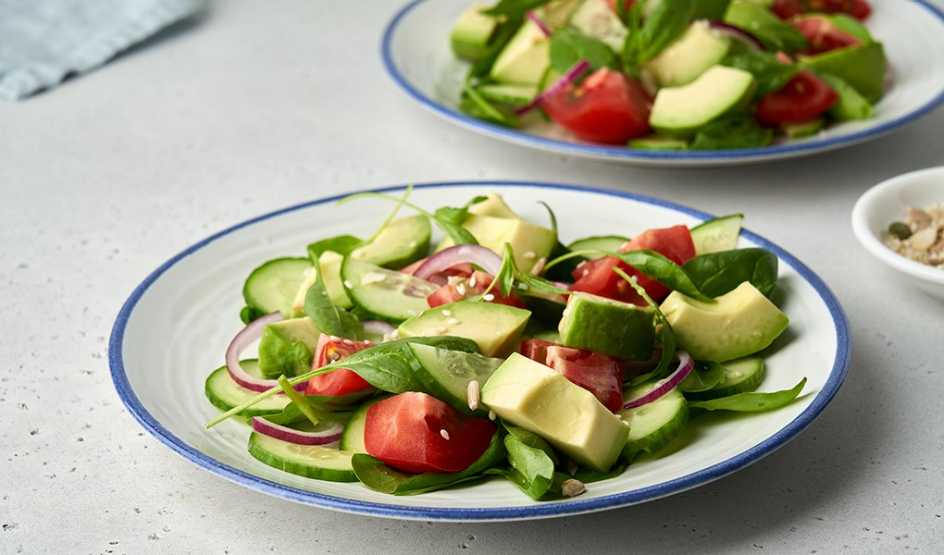 A close-up view of two plates of a vegetable salad