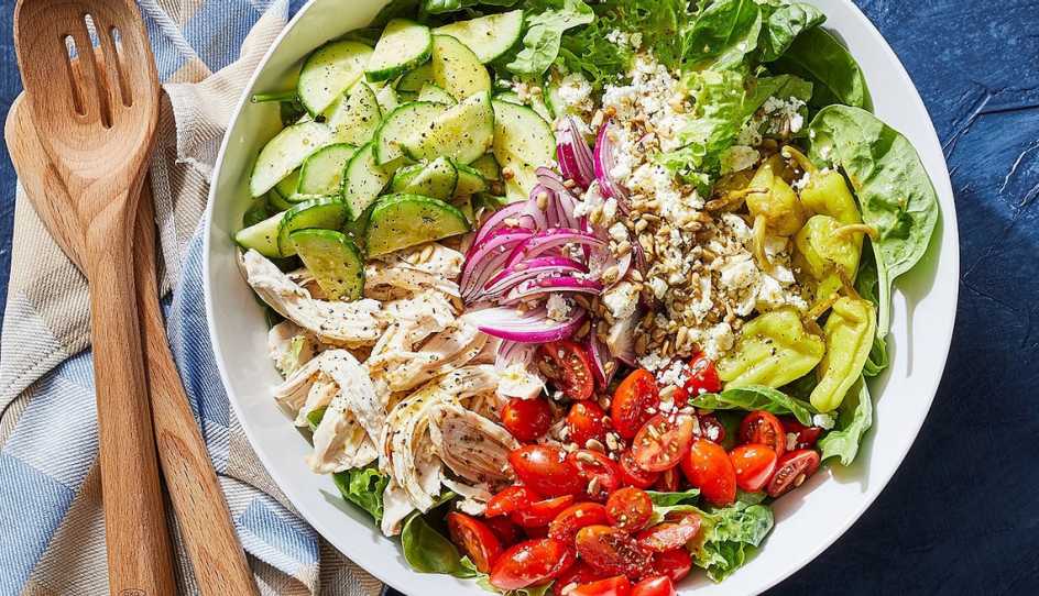 A close-up view of a chopped power salad with chicken in a bowl